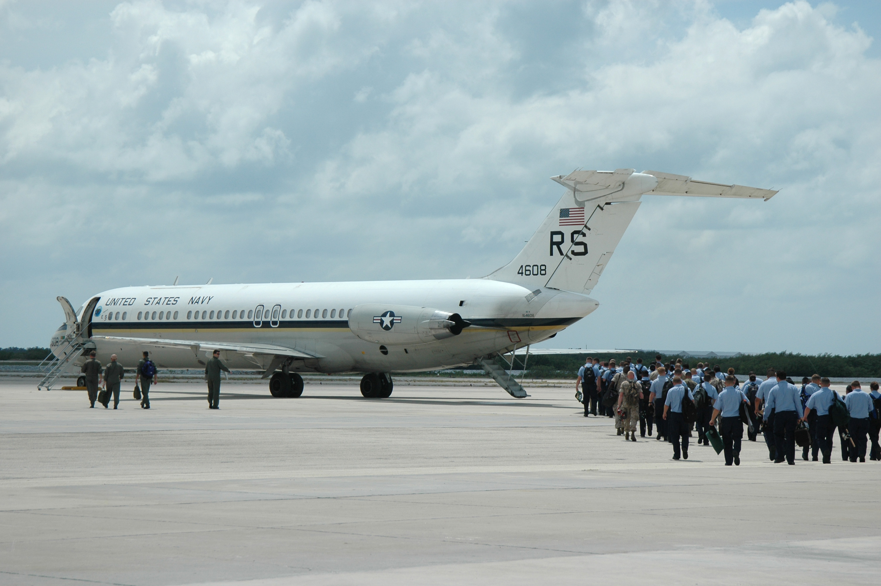 US Navy 050919-N-0000B-002 Over 90 Sailors and Marines assigned to the ^ldquo,Rough Raiders^rdquo, of Strike Fighter Squadron One Two Five (VFA-125), embark aboard a Navy C-9B Skytrain II transport aircraft 