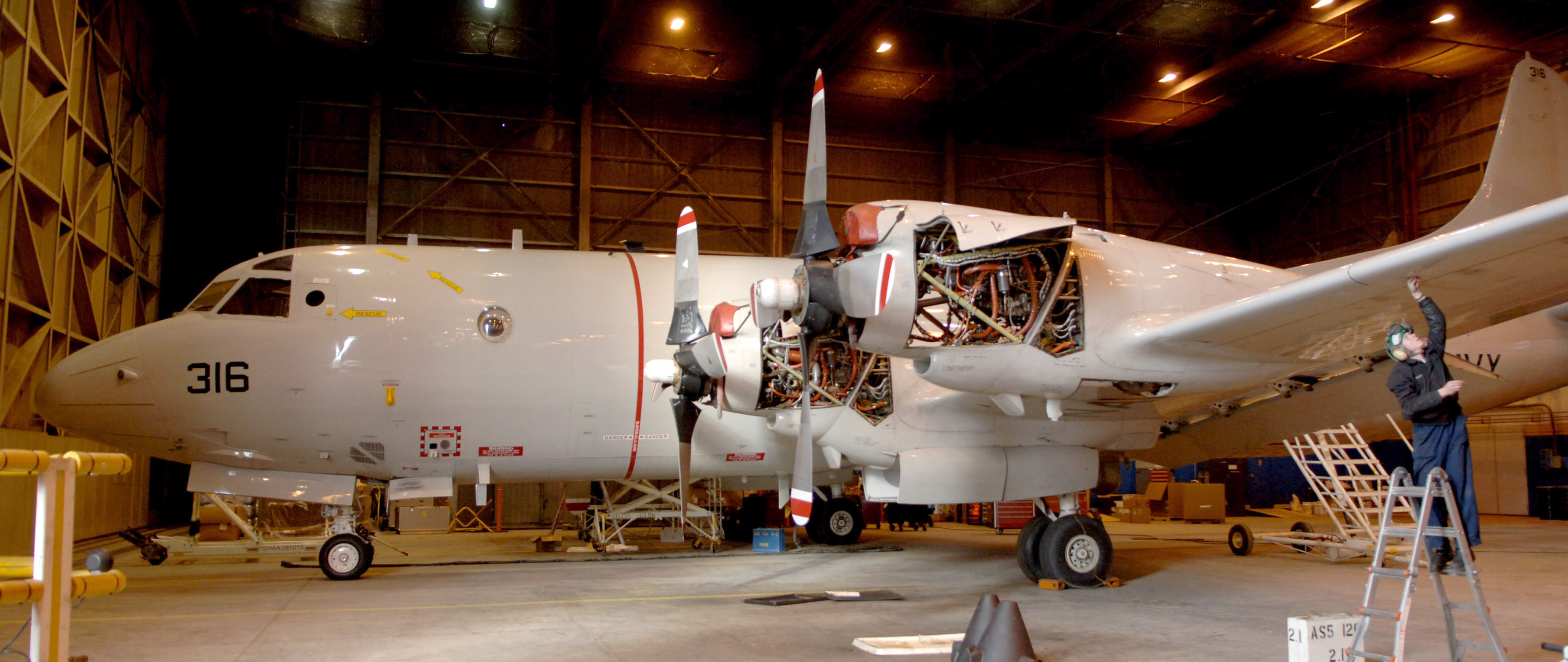 US Navy 060126-N-8228R-585 Aviation Structural Mechanic 3rd Class Steve Hastey assigned to Patrol Squadron Two Six (VP-26), conducts routine maintenance on a P-3C Orion