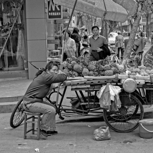A woman sleeping on fruit stand