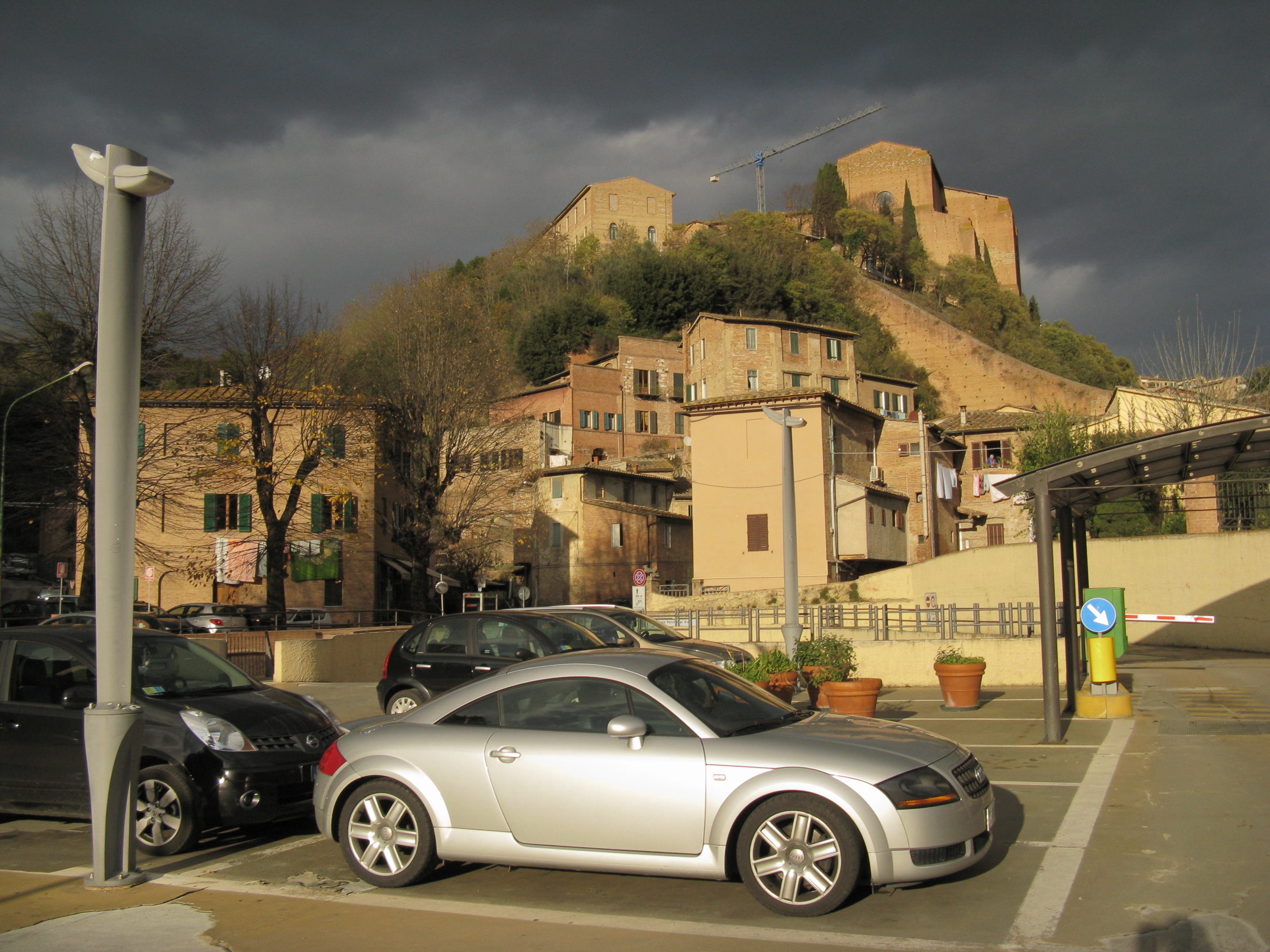 Siena Parking lot with sun and snow clouds
