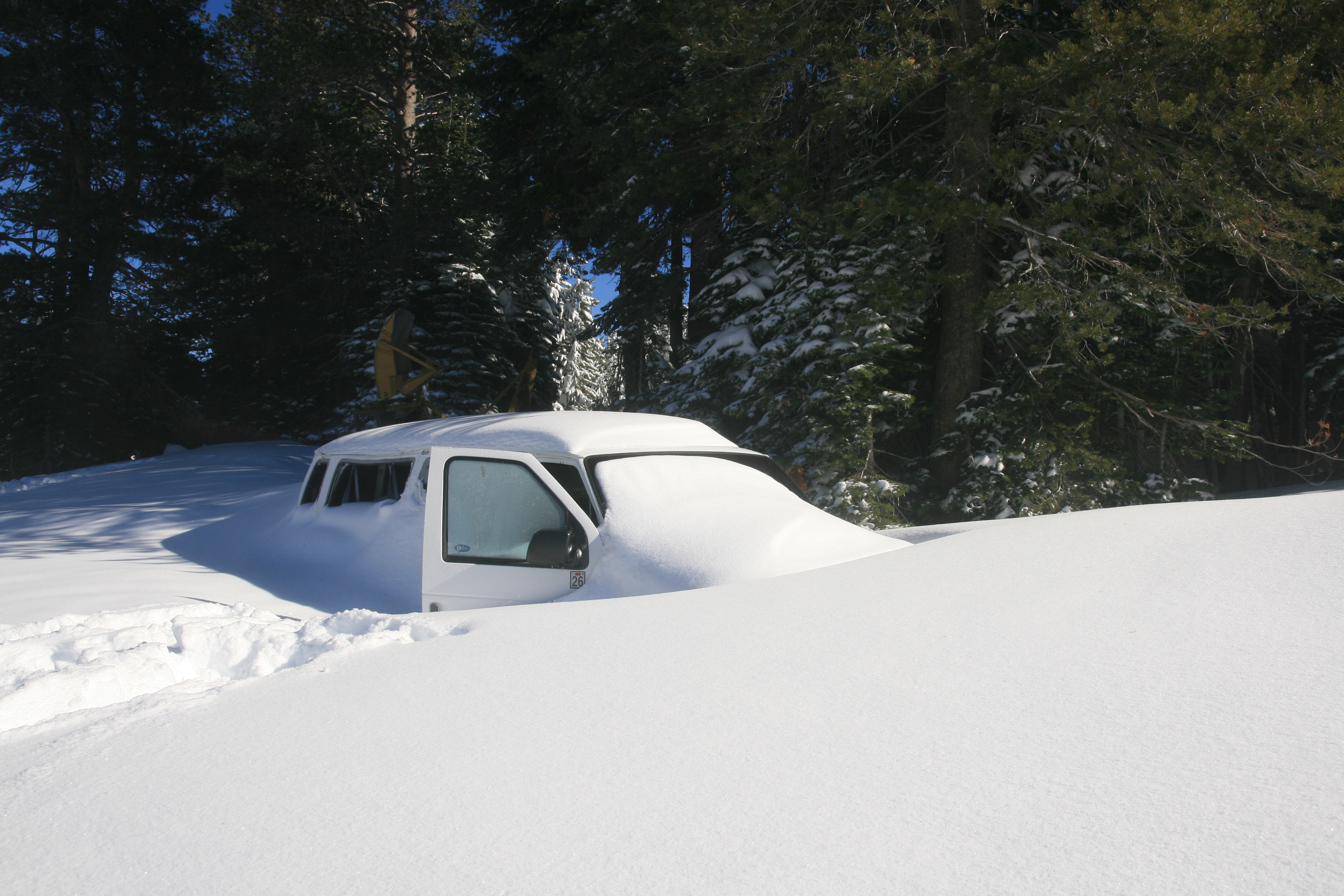 Van covered by snow in Boreal California