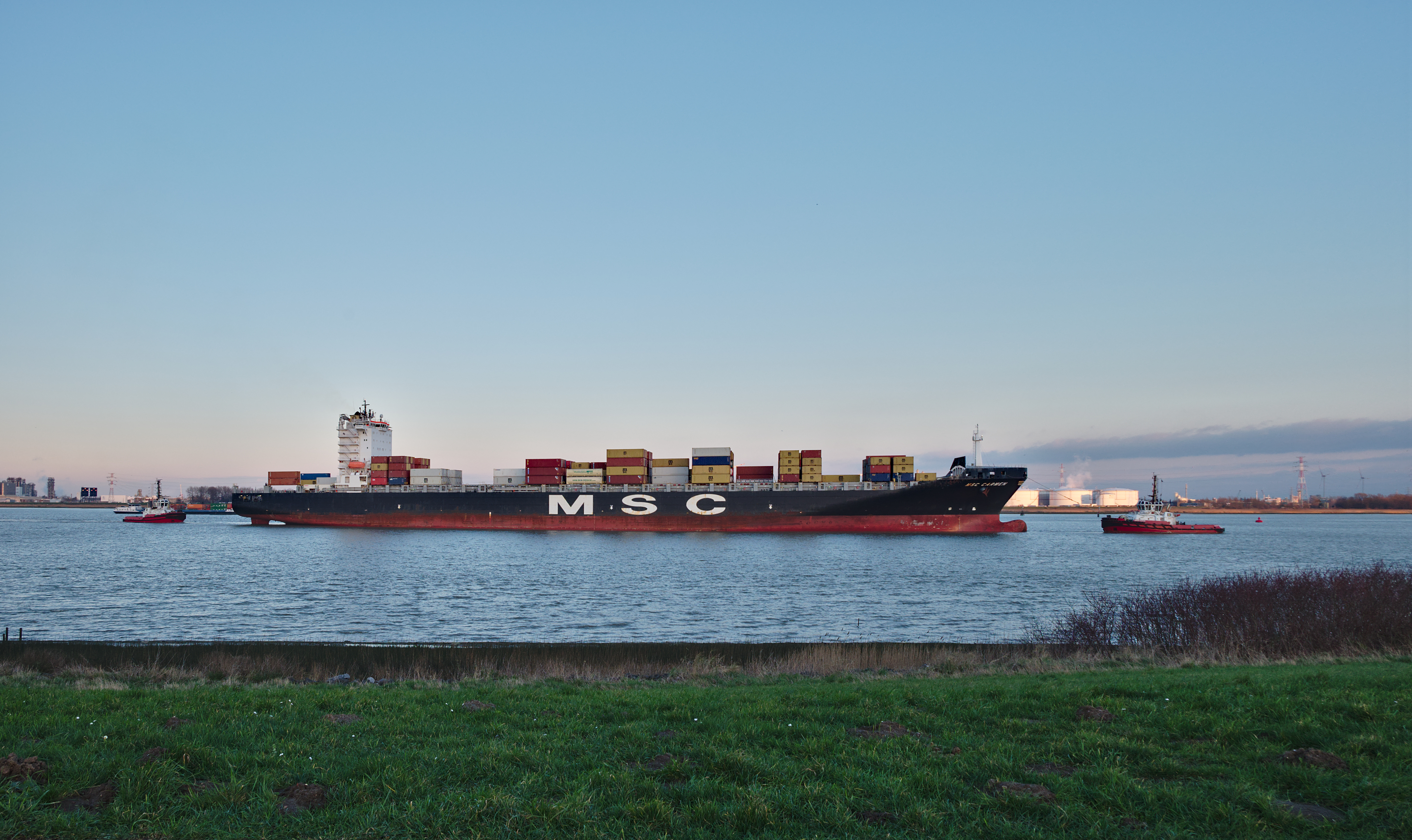 Container ship being towed in the Scheldt towards the Port of Antwerp, seen from Doel, Belgium (DSCF3886)
