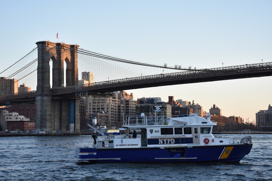 NYPD police boat, Brooklyn Bridge and Downtown Brooklyn at sunset