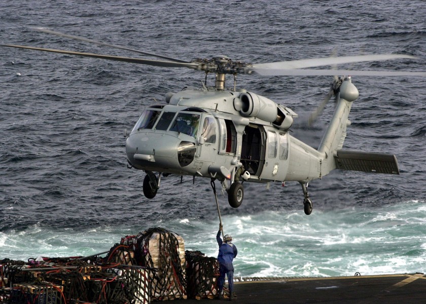 US Navy 020924-N-9593M-026 A SH-60 ^ldquo,Sea Hawk^rdquo, Helicopter assigned to Helicopter Combat Support Squadron Five (HC-5) prepares to receive a sling loaded pallet