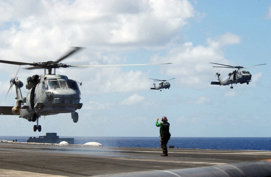 US Navy 030216-N-7265L-019 The Landing Signal Enlisted (LSE) signals the pilot of an SH-60B Seahawk assigned to the 