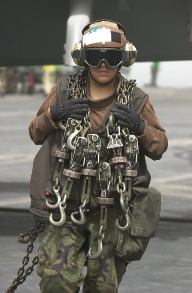US Navy 030417-N-2385R-011 Airman Ana Tavira from Bloomington, Calif., crosses the flight deck after taking the tie down chains off of an aircraft on the flight deck aboard USS Nimitz (CVN 68)