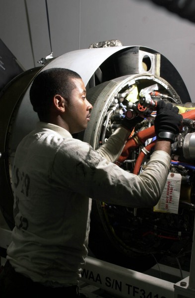 US Navy 030418-N-0413R-001 Aviation Machinist^rsquo,s Mate 2nd Class Isaac Sampson of Baltimore, Md., inspects the Turbo Fan Thirty Four (TF-34) jet engine of a S-3B Viking