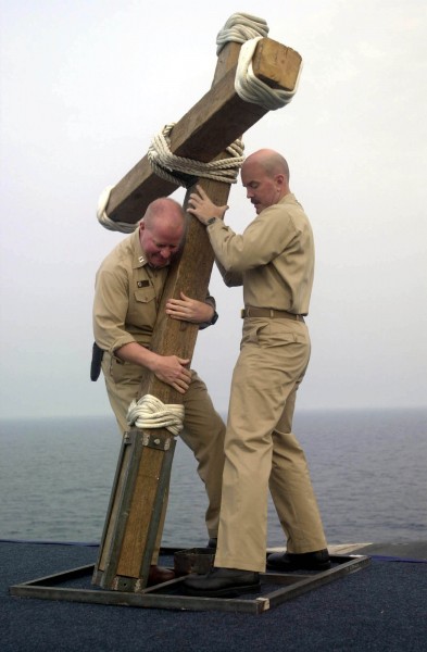 US Navy 030420-N-8273J-001 Chaplain Dan Reardon and Chaplain Kyle Fauntleroy work together to put up a crucifix for the Easter Sunrise Service on the flight deck of USS Nimitz (CVN 68)