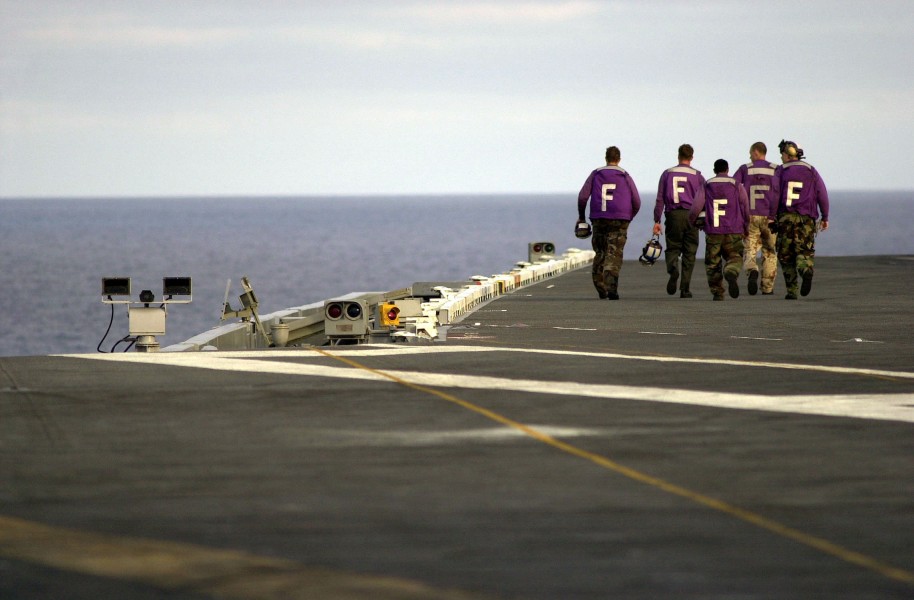 US Navy 030731-N-6213R-204 Aviation Boatswain's Mates walk toward the bow of USS John C. Stennis (CVN 74) after a fueling evolution