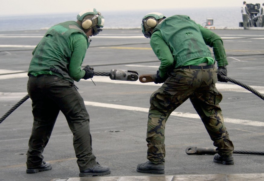 US Navy 030818-N-6713R-114 Flight deck sailors attach a new arresting cable to the arresting gear assembly during flight operations aboard USS John C. Stennis (CVN 74)