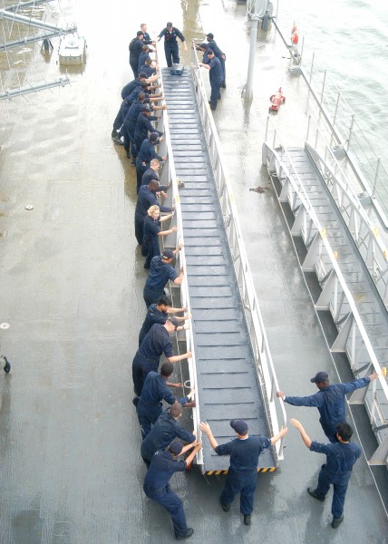 US Navy 030825-N-9860Y-008 USS Blue Ridge (LCC 19) deck department Sailors move one of the ship's brows in preparation for getting underway following a port visit