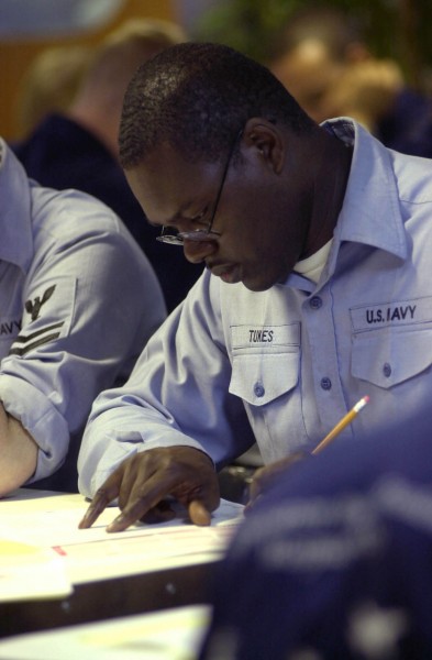 US Navy 030904-N-1577S-002 While taking the Navy 1st Class Petty Officer advancement exam aboard USS Nimitz (CVN 68), a sailor reviews a question before choosing an answer