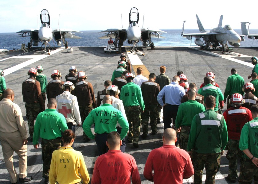 US Navy 030915-N-9907G-501 Crewmembers scour the flight deck during a Foreign Object Damage (FOD) walk down aboard USS Theodore Roosevelt (CVN 71)