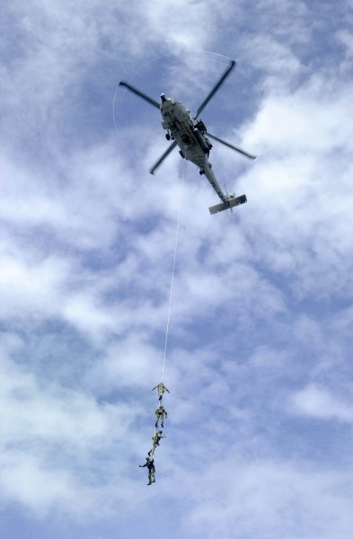US Navy 031005-N-2385R-004 Explosive Ordnance Disposal Mobile Unit Eleven Detachment One (EODMU-11, DET 1) suspend themselves from a repelling rope