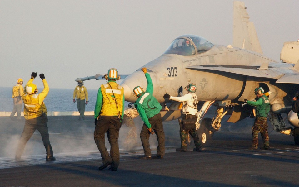 US Navy 031028-N-7732W-124 Flight deck personnel perform final safety inspections prior to launching an F-A-18C Hornet