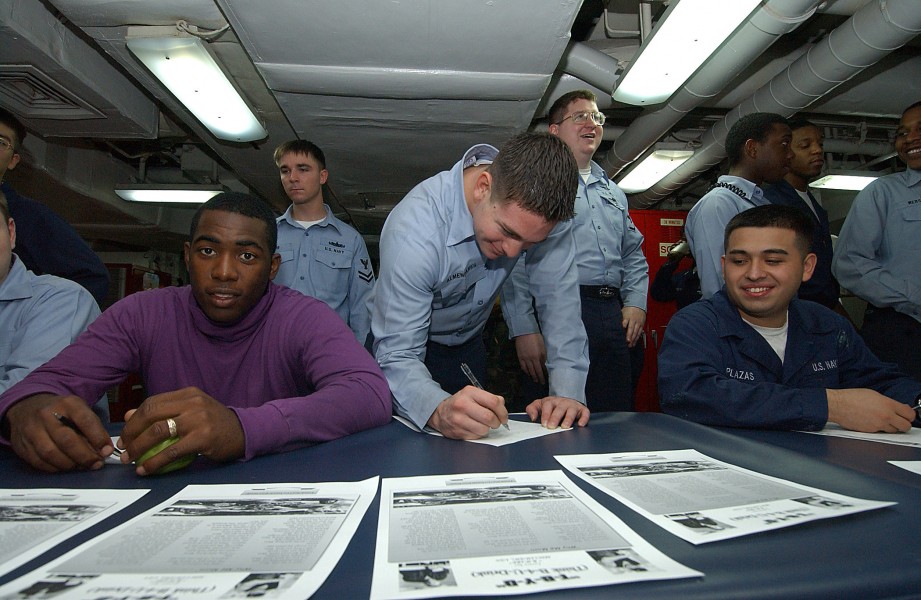 US Navy 031214-N-1045B-001 USS George Washington (CVN 73), Commanding Officer, Capt. Martin J. Erdossy, enjoys seeing Airman Craig Land, from Saucier, Miss., sign a 
