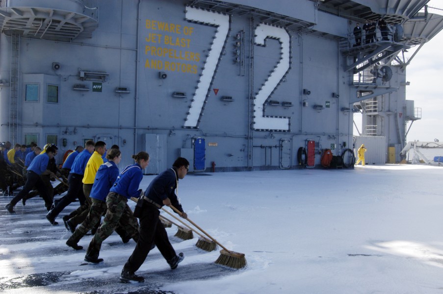 US Navy 040603-N-9593M-067 USS Abraham Lincoln (CVN 72) Aviation Boatswain's Mates perform a flight deck scrub following a counter-measures wash down test on the ship^rsquo,s flight deck