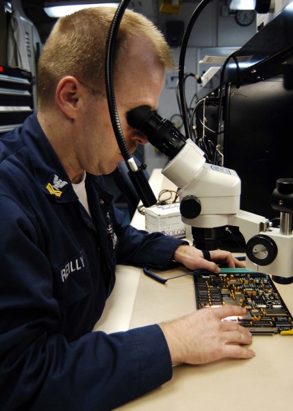 US Navy 041215-N-4166B-069 Aviation Electronics Technician 1st Class Jim Reilly inspects a Forward Looking Infrared (FLIR) Servo Control Card