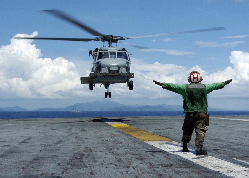 US Navy 050110-N-6817C-056 A Landing Signals Enlisted man directs an SH-60B Seahawk helicopter, assigned to the Saberhawks of Helicopter Anti-Submarine Squadron Light Four Seven (HSL-47)