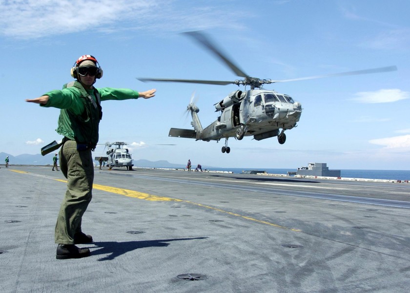 US Navy 050111-N-6817C-190 A Landing Signals Enlisted man directs an HH-60H Seahawk to a safe landing on the flight deck aboard USS Abraham Lincoln (CVN 72)