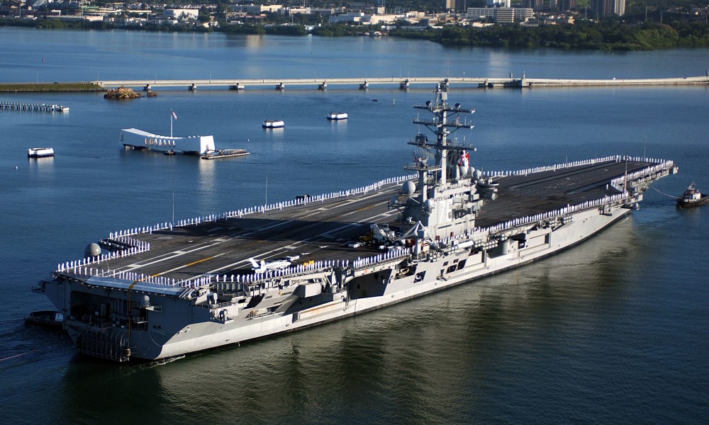 US Navy 050122-N-0610T-089 Sailors man the rails and render honors to the USS Arizona Memorial as the Nimitz-class aircraft carrier USS Ronald Reagan (CVN 76) pulls into Naval Station Pearl Harbor, Hawaii