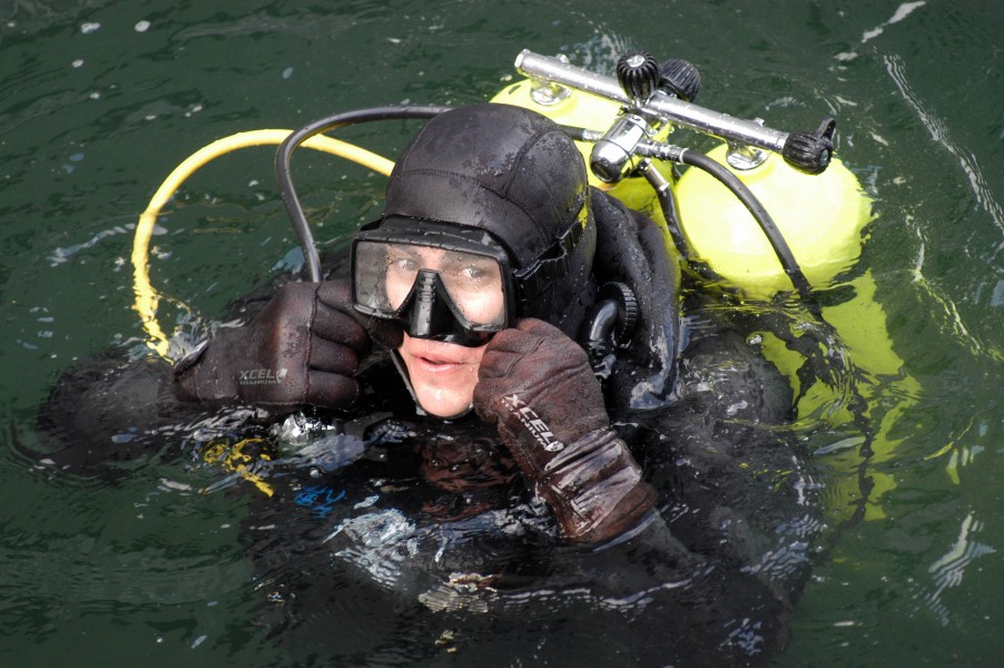 US Navy 050202-N-3390M-269 Operations Specialist 2nd Class Mathew Medeiros checks his goggles during diving proficiency training on board Naval Station Everett