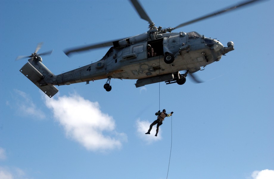 US Navy 050214-N-7265L-026 Sailors assigned to Explosive Ordnance Disposal Mobile Unit Eleven (EODMU-11), Detachment Nine, fast rope from an HH-60H Seahawk helicopter