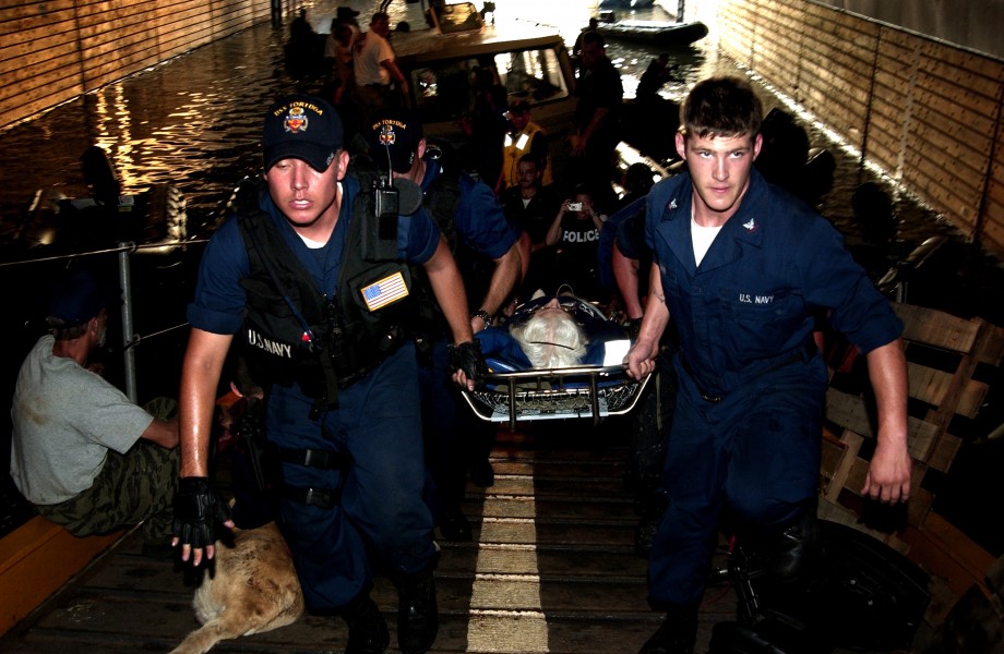 US Navy 050905-N-6436W-152 U.S. Navy Sailors carry an injured New Orleans citizen through the open well deck aboard the dock landing ship USS Tortuga (LSD 46)