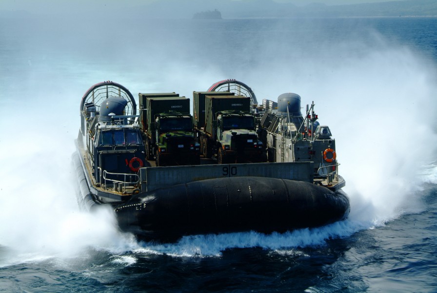 US Navy 060303-N-4772B-230 A Landing Craft, Air Cushion (LCAC) loaded with equipment from the 31st Marine Service Support Group (MSSG) makes its way toward the stern gate of the amphibious dock landing ship USS Harpers Ferry (L