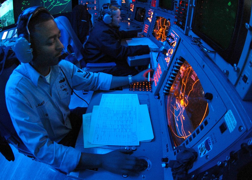 US Navy 060502-N-9079D-002 Operations Specialist 2nd Class Anthony S. Lampkin tracks contacts in Combat Direction Center (CDC) aboard USS Abraham Lincoln (CVN 72)