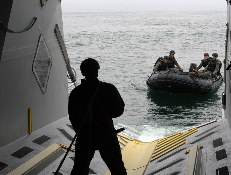 US Navy 060508-N-4021H-119 Sailors assigned to Naval Special Clearance Team One (NSCT-1), prepare to dock in the well deck aboard experimental boat ship Stiletto