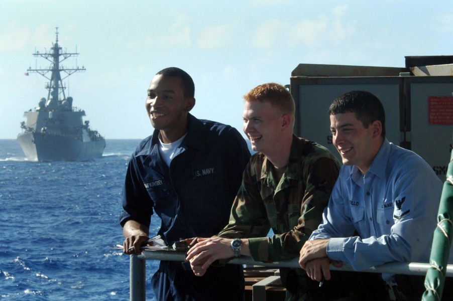 US Navy 060613-N-8604L-044 Sailors aboard USS Kitty Hawk (CV 63) watch as the ship conducts a replenishment at sea (RAS) with the underway replenishment oilier USNS Tippecanoe (T-AO 199)