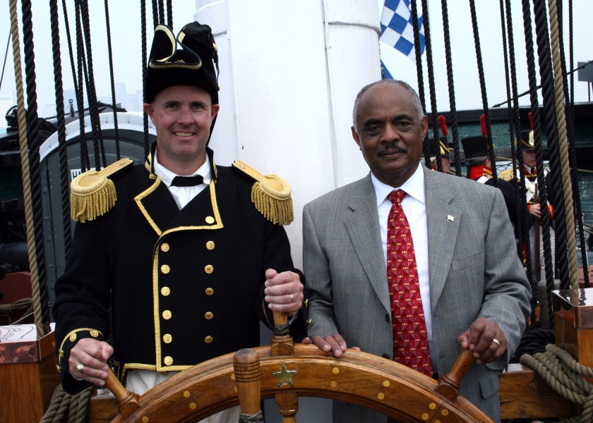 US Navy 060623-N-5367L-002 Commanding Officer, Cmdr. Thomas C. Graves, and Assistant Secretary of the Navy for Installations and Environment, the Honorable B.J. Penn, man the helm aboard USS Constitution