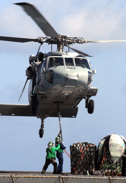 US Navy 070515-N-3038W-210 Sailors from USNS Bridge (T-AOE 10) attach supplies to an MH-60S Seahawk from the 