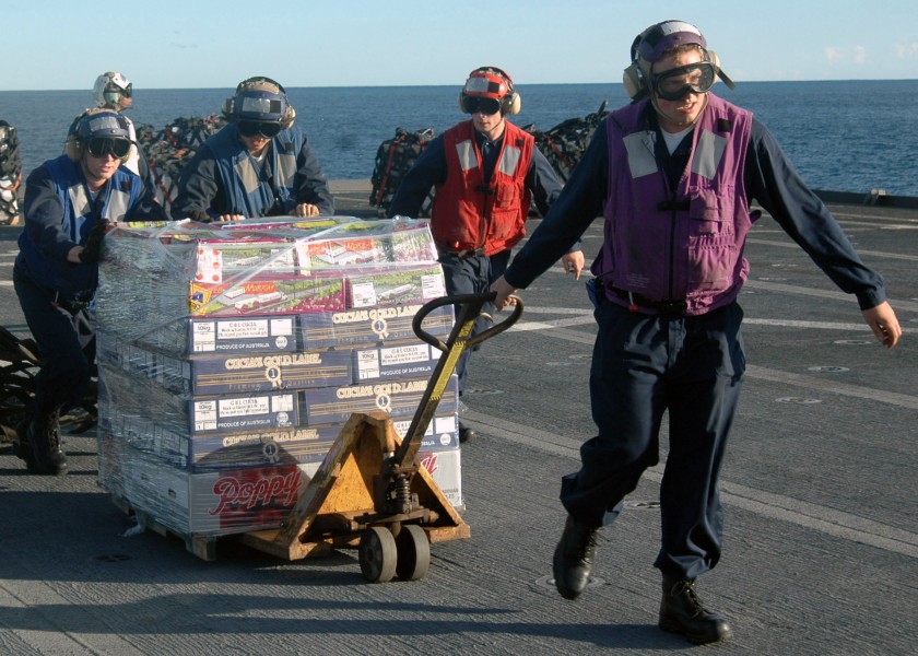 US Navy 070628-N-6710M-006 Members assigned to the flight deck crew transit supplies during a vertical replenishment (VERTREP) from the flight deck of the Dock landing ship USS Tortuga (LSD 46)