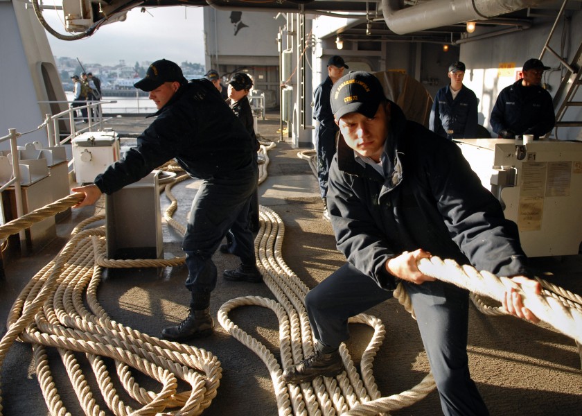 US Navy 070707-N-7981E-028 Seaman Jacob Albon and members of deck department single up lines as Nimitz-class aircraft carrier USS Abraham Lincoln (CVN 72) gets underway from her home port