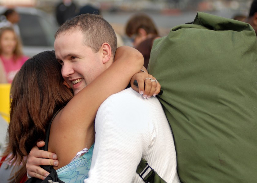US Navy 070820-N-7981E-212 Fireman Anthony Jaques hugs his wife after his arrival home aboard the Nimitz-class aircraft carrier USS Abraham Lincoln (CVN 72)