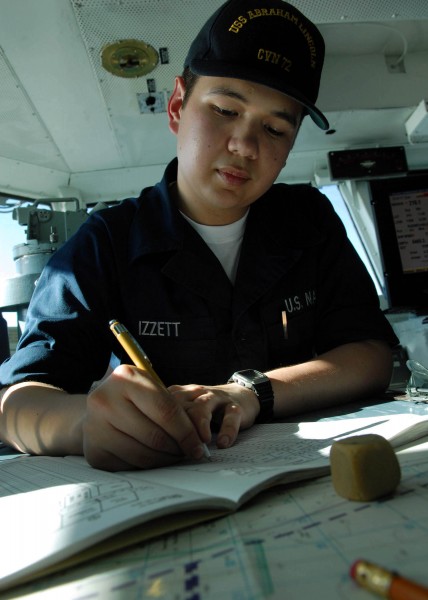 US Navy 080124-N-7981E-085 Quartermaster Seaman Jonathan Izzett makes entries to the ship's position log while assisting the Quartermaster of the Watch on the bridge of the USS Abraham Lincoln