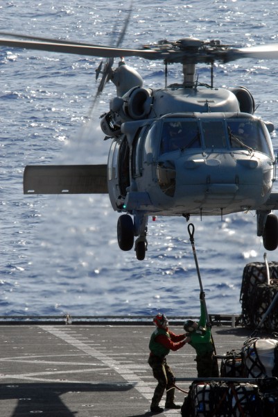 US Navy 080710-N-1635S-005 Personnel aboard the Military Sealift Command fast combat support ship USNS Bridge (T-AOE 10) attach a cargo pendant to an MH-60S Seahawk
