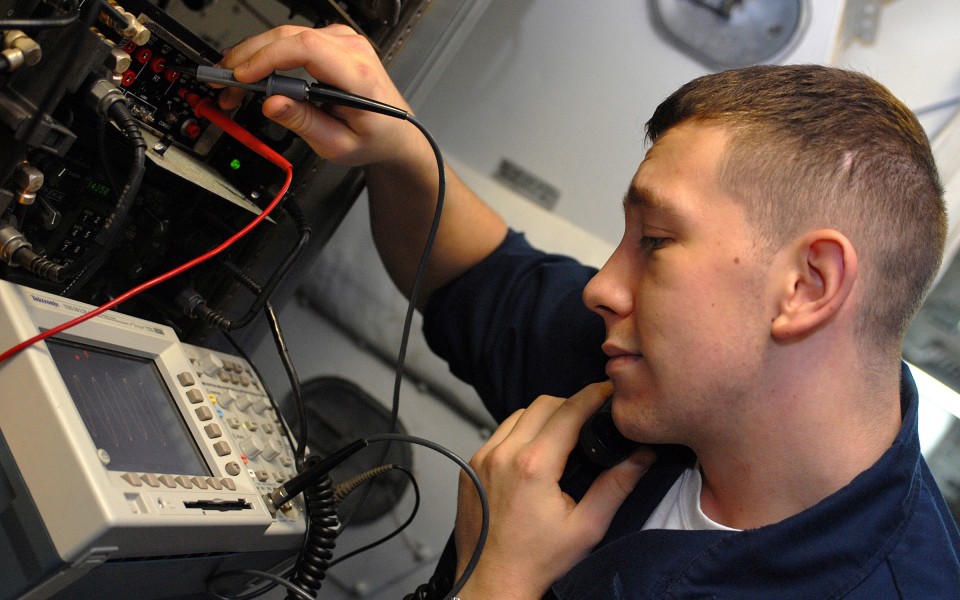 US Navy 080724-N-5384B-129 Electronics Technician 3rd Class Craig Pote, from Waterford, Mich., test the single channel group and airborne radio system