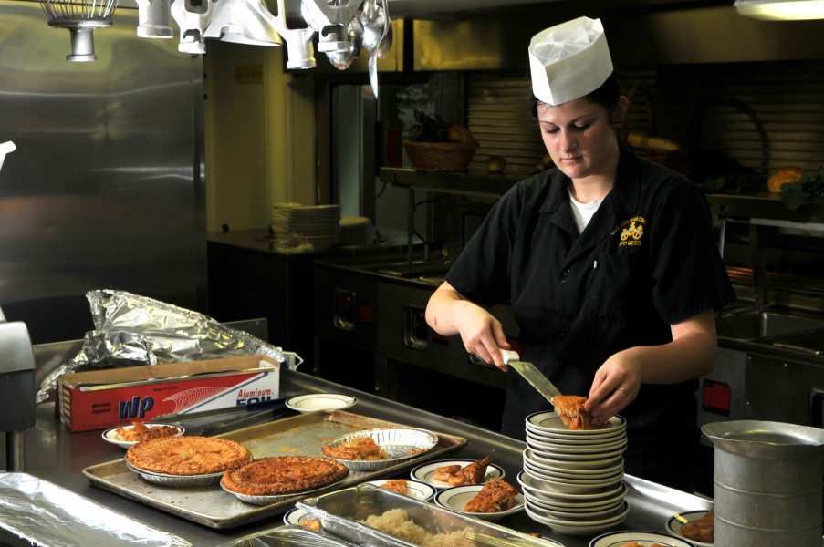 US Navy 080731-N-7981E-116 Operations Specialist Seaman Apprentice Amy Caccamise prepares pie servings