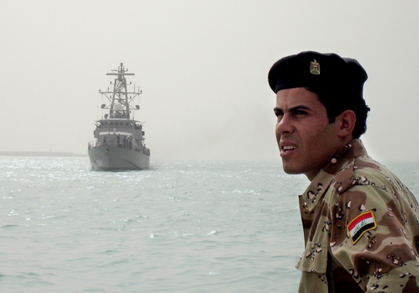US Navy 080813-N-5068C-008 An Iraqi sailor looks on from the pier as the coastal patrol boat USS Firebolt (PC 10) arrives at the port of Umm Qasr
