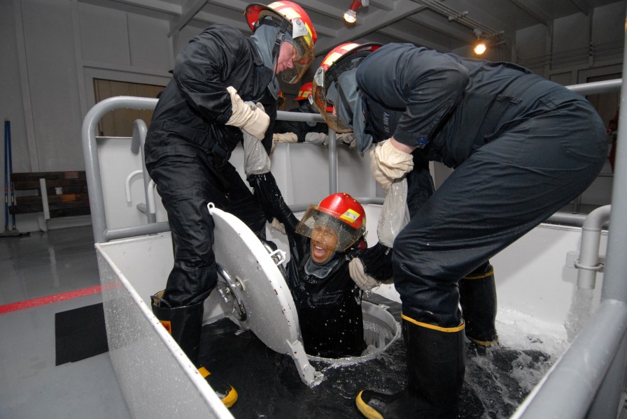 US Navy 080819-N-6936D-124 Sailors assigned to the amphibious assault ship USS Essex (LHD 2) work together to help a shipmate exit from a flooding space