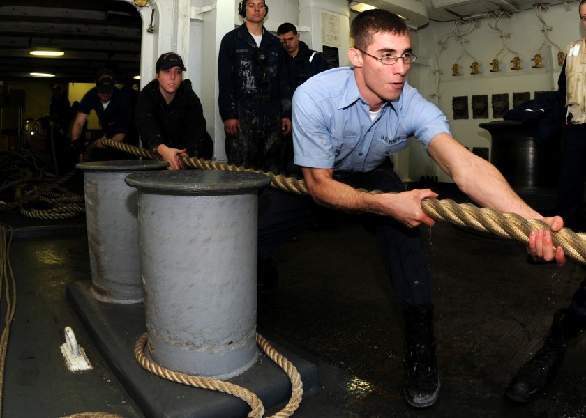 US Navy 081201-N-9898L-036 Seaman Chase Butler heaves a mooring line