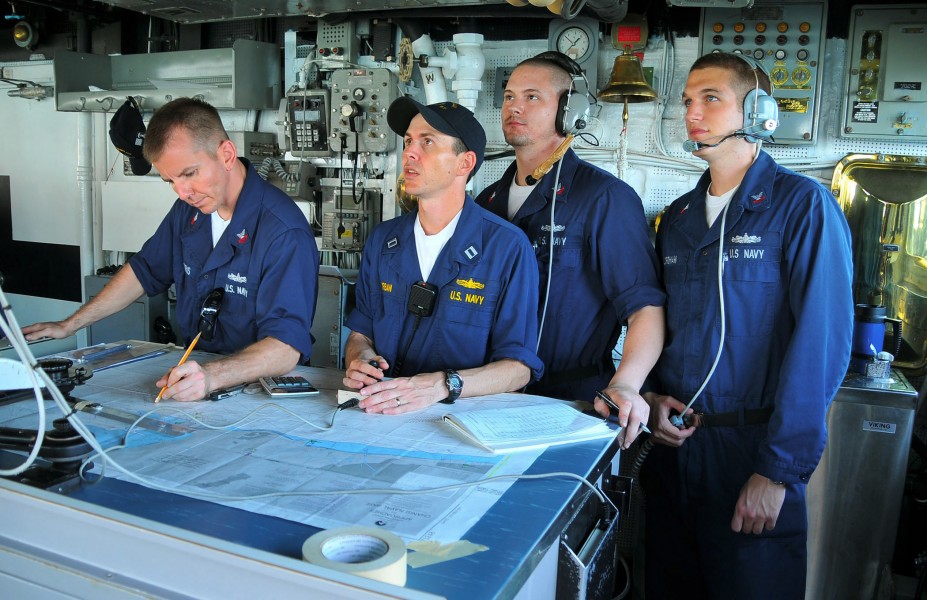 US Navy 090626-N-4774B-036 Navigation officer Lt. Michael Hurban, center, digitally charts a course on the bridge of the guided-missile cruiser USS Lake Champlain (CG 57)