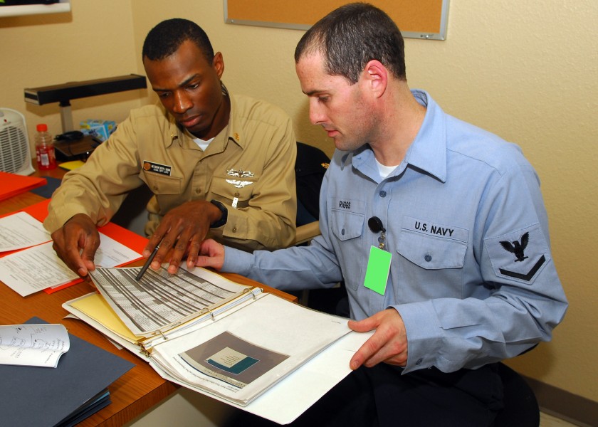 US Navy 090708-N-9247P-012 Chief Legalman Joseph Brown, and Aviation Electrician's Mate 3rd Class Stephen Riggs, review new training material for USS Abraham Lincoln's (CVN 72) Legal Department