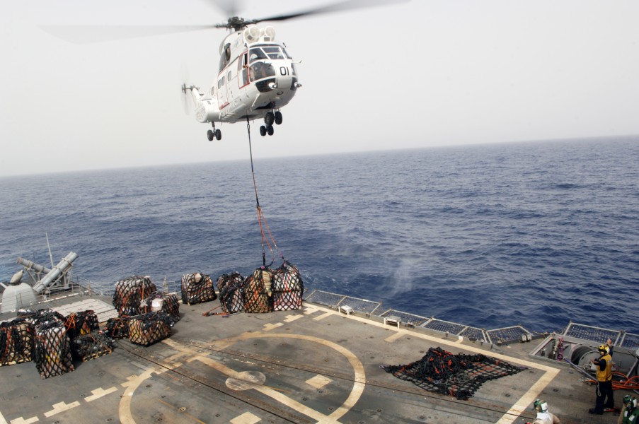 US Navy 090716-N-9301D-150 A SA-330 Puma helicopter assigned to the combat stores ship USNS San Jose (T-AFS 7) drops a load of stores onto the flight deck of USS Anzio (CG 68) during a vertical replenishment