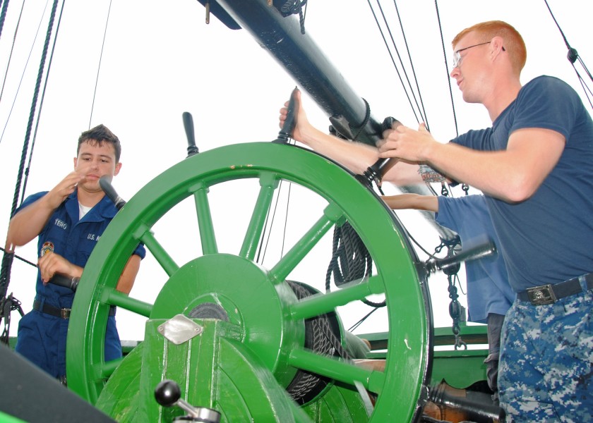 US Navy 100714-N-5647H-170 Fireman Apprentice Esteban Quintero, left, and Airman Dylan Roberts, both assigned to USS Constitution, steer the rudder aboard the Friendship of Salem