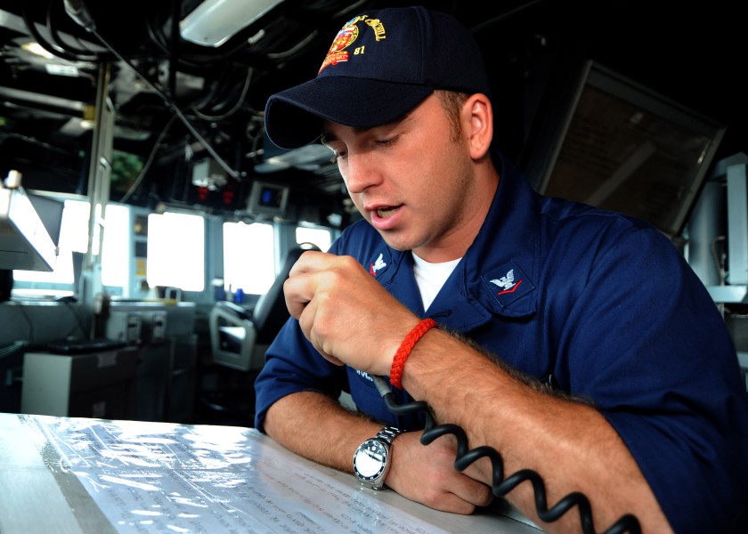 US Navy 100917-N-3705H-333 Boatswain's Mate 3rd Class Michael Bowden, from Augusta, Ga., announces the start of flight quarters over the ship's 1MC