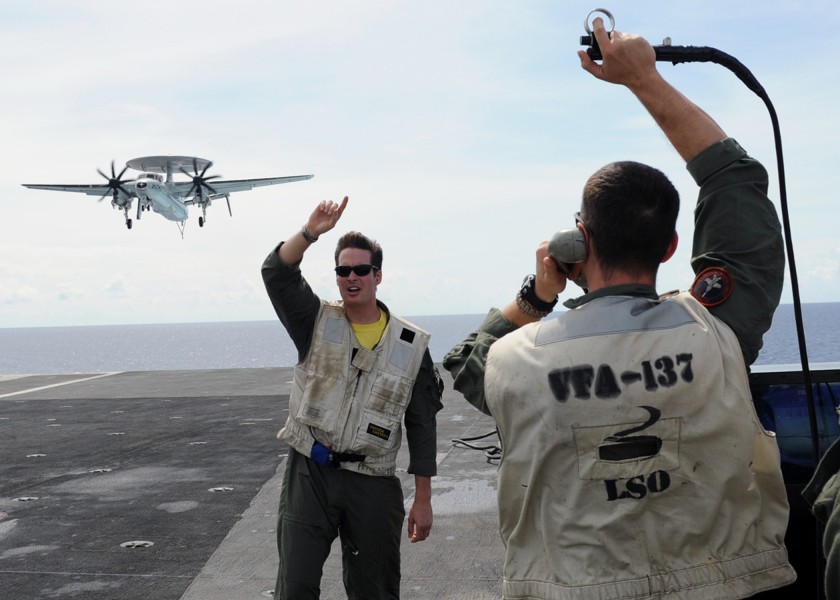 US Navy 101006-N-4973M-061 Landing signal officers communicate with the pilots as aircraft make their approach to land on the flight deck of the ai